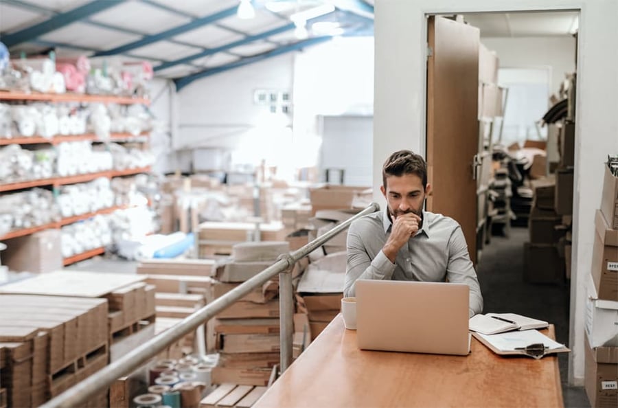 man at computer in warehouse