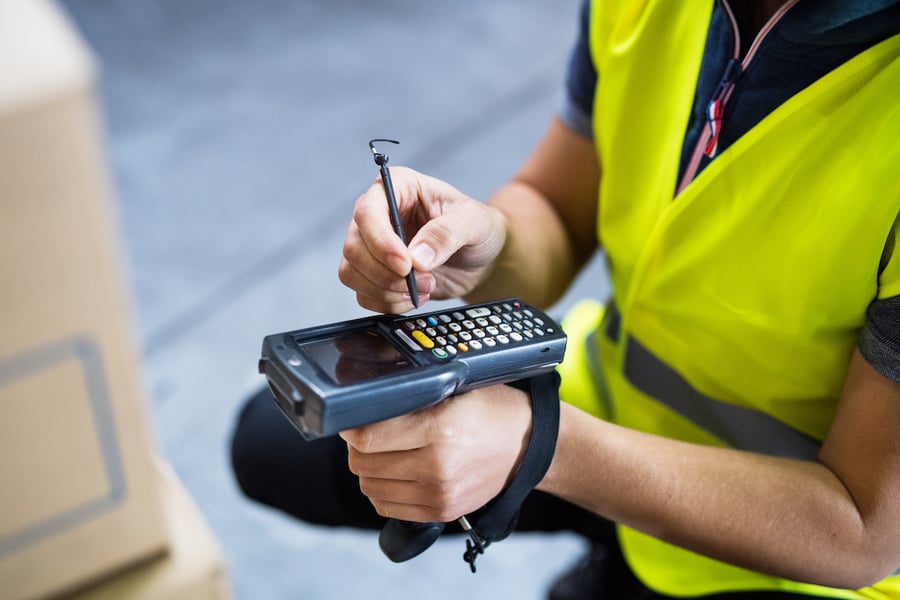 male warehouse worker barcode scanner