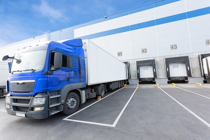 Blue truck and gates of distribution warehouse
